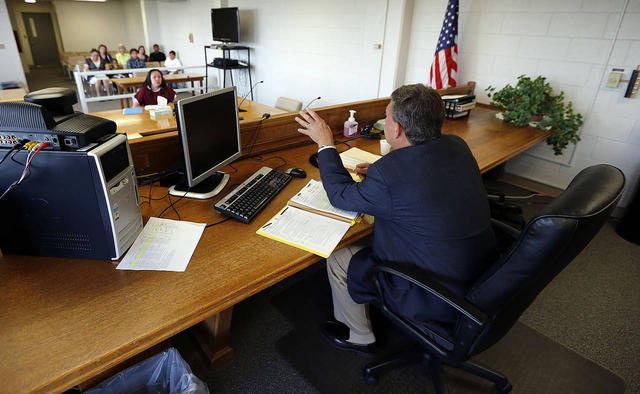 Photo Credit: Ravell Call, Deseret News. Clark Harms, right, member of the Utah Board of Pardons and Parole, speaks during the parole hearing for Mae Johnson at the Utah State Prison, Tuesday, July 7, 2015. 